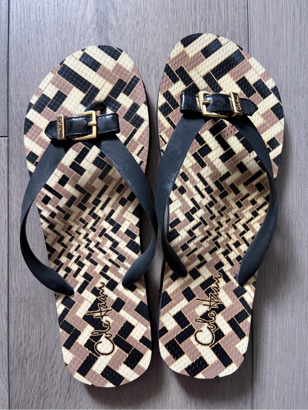 Cole Haan Black and Tan Geometric Flip Flops with Gold Buckle